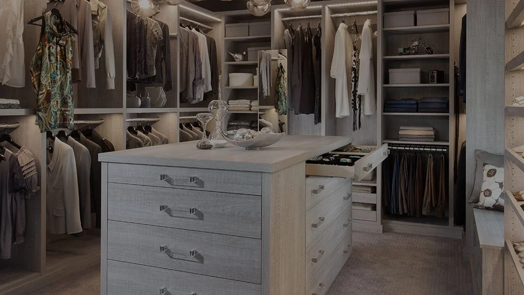 Custom walk-in closet design in Nassau County with shelving, drawers, hanging storage, and organization features