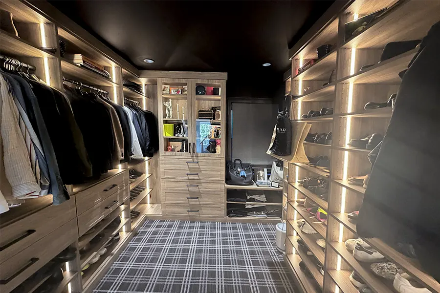  Luxury après-ski walk-in closet with LED lighting, custom shelving, drawers, and shoe.