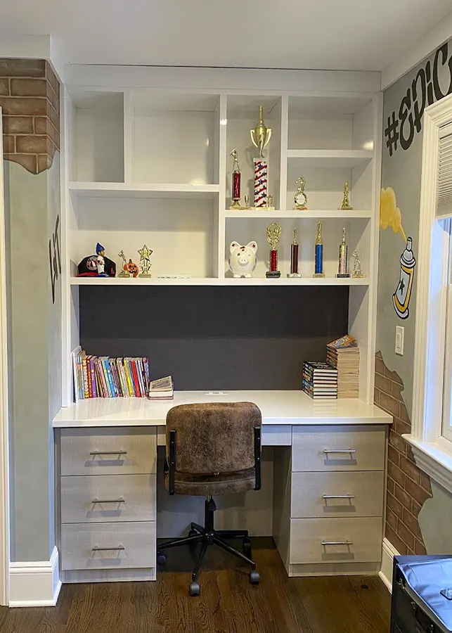 Custom study space with built-in storage, open shelving, drawers, and organized workspace design.