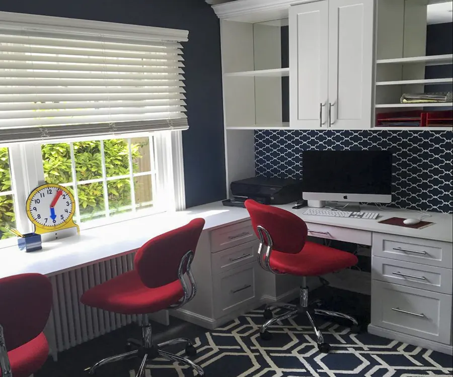 Custom home office featuring a built-in desk, white storage cabinets, drawer organization, open shelving, and workspace designed by Custom Closets A&G Designs.