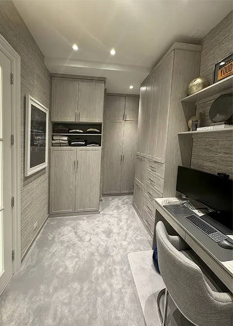 Custom wardrobe storage system with hanging space, drawers, shelving, and organized storage designed for a modern bedroom.