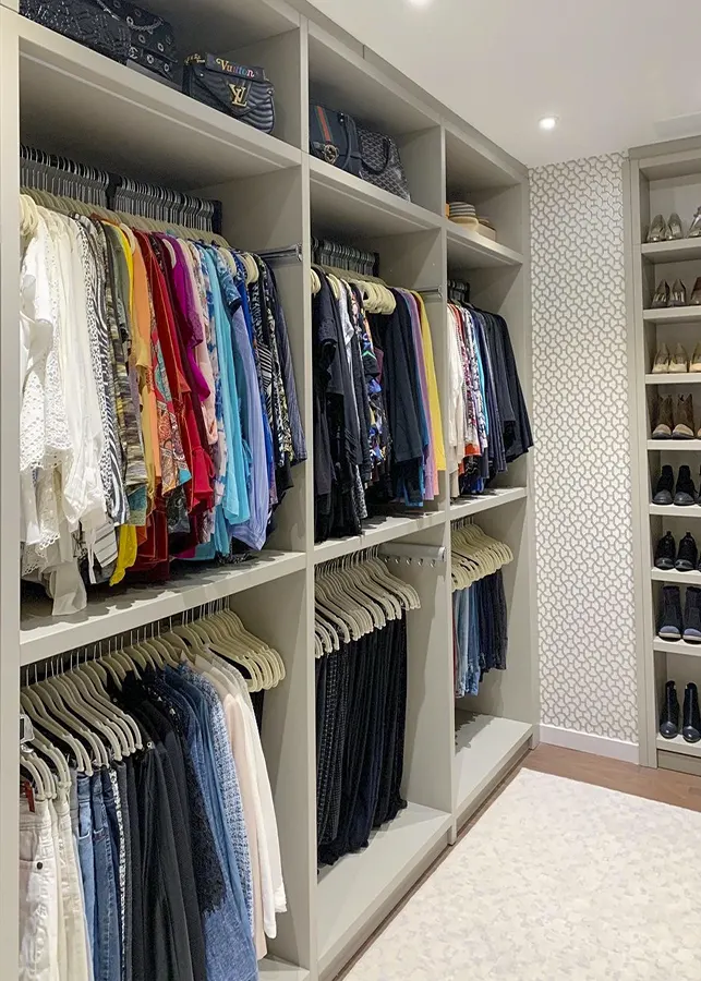Custom walk-in closet with double hanging storage, shelving, and shoe organization.