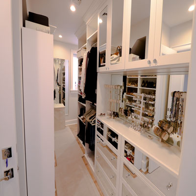 walk-in closet features mirror shaker doors and mirror backsplash